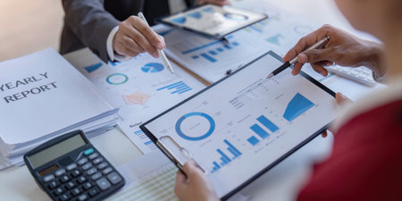 Bookkeeper team accountant or financial expert, economist accounting money with statistics graphs pointing on the accounts for investment results and income Company expenditureの写真素材