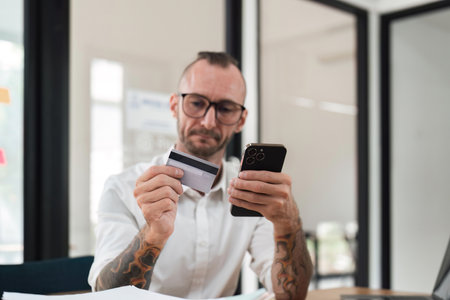 Man using mobile smart phone and credit card making online payment with mobile phone. Online shopping conceptの写真素材