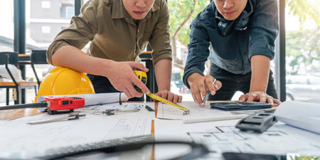 engineer working in office with blueprints, inspection in workplace for architectural plan, construction project ,Business constructionの写真素材