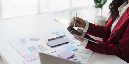 Young business woman holding stylus pen with digital tablet screen. business financial conceptの写真素材