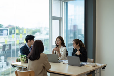Group of young asian creative business brainstorm meeting presentation, discussing roadmap to product launch, planning, strategy new startup project in officeの写真素材