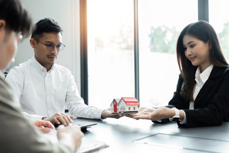 Real estate agent talked about the terms of the home purchase agreement, Home sales and home insurance conceptの写真素材