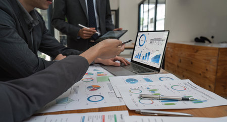 Close up of business people gather brainstorm discuss financial statistics at office meeting....
