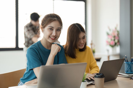 Portrait young female smile with her team in the backgroundの写真素材