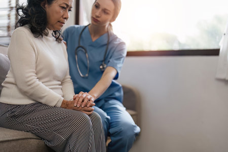 Empathy, trust and nurse holding hands with patient for help, consulting support and healthcare advice. Kindness, counseling and medical therapy in nursing home for hope, consultation and psychologyの写真素材