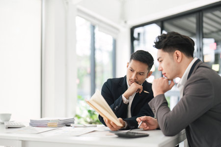 Asian business advisor meeting to analyze and discuss the situation on the financial report in the meeting room. Investment Consultant, Financial , teamwork ,brainstorming ,startup and accountingの写真素材