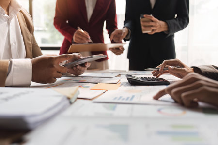 Business team analyzing income charts and graphs with calculator and tablet. Close up. Business analysis and strategy conceptの写真素材