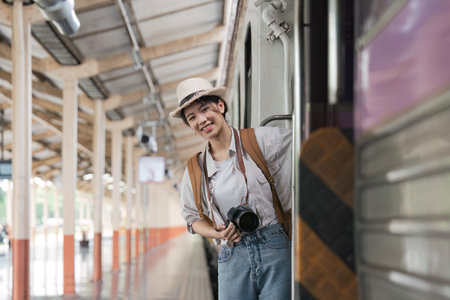 Portrait attraction asian woman boarding a train at train station for travel. Travel concept