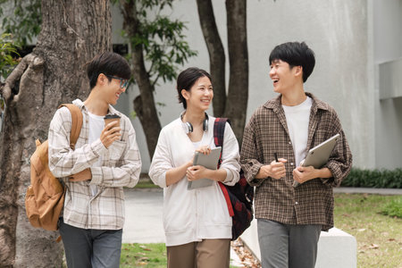 Education, friends and college with students on campus with books for learning, scholarship or knowledge. Study, future or university with people walking to class for back to school, academy or examの写真素材