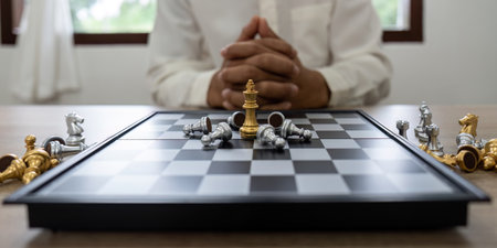 Winner. shot of golden king surrounded with silver chess pieces on chess board game competition ,...