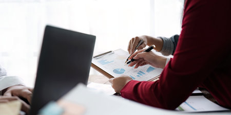 Close up business people meeting to discuss the situation on the market. Business team analyzing income charts and graphs. Business Financial Conceptの写真素材