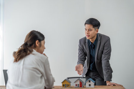 Real estate agent houses to customers after agreeing to make a home purchase agreement and make a loan agreement. Discussion with a real estate agentの写真素材