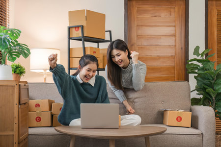 Sell products to business owners online. Focus on the face of two women in expressing joy to a friend whose online sales exceeded their expectationsの写真素材