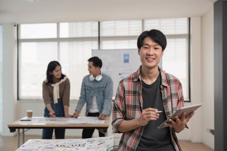 Designer man with tablet planning application for mobile phone. UX UI designer conceptの写真素材