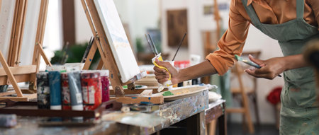 Close up portrait of beautiful african american and authentic young female artist or painter create art piece. Detailed work for personal creative projectの写真素材