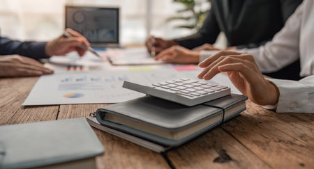 Businessman team analyzing financial statement finance task with calculator. Wealth management conceptの写真素材