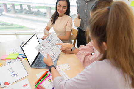 ux developer and ui designer presenting and testing mobile app interface designin meeting at modern...