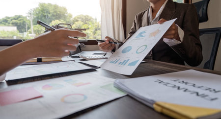 Close up of Business team analyzing income charts and graphs with modern laptop computer. Business analysis and strategy conceptの写真素材