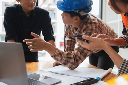 Architect engineer design working meeting, working, discussing, plan, designing, measuring layout of building blueprint in construction siteの写真素材