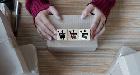 Hand arranging wood block with icon business strategy and online shopping. online sales, success and...