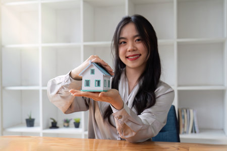 Property insurance, real estate broker or home insurance agent gesture protect house, contract document, security concept, protection. Insurance rent buy sell mortgageの写真素材