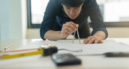 Engineer planing and working on table construction working at office