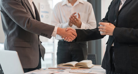 Young asian business shaking hands successful making a deal, business woman handshake. Business partnership meeting handshake conceptの写真素材
