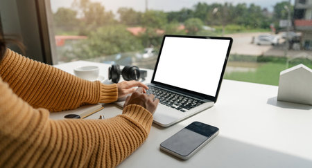 Young asian woman using laptop computer with blank screen for mock up template, technology and...