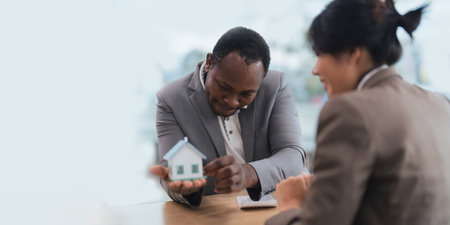 African american real estate agent showing house to his clients after contract signing, concept for real estate, moving house or renting property with diversity ethnicityの写真素材