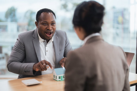 African american real estate agent showing house to his clients after contract signing, concept for real estate, moving house or renting property with diversity ethnicityの写真素材
