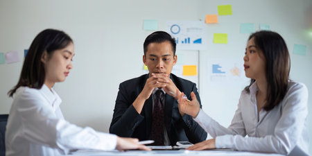 Asian young businesspeople are stress while working in meeting room, Tired businessman with headache at office, feeling sick at workの写真素材