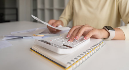 Plan finance concept. Asian young woman hand using calculate to calculating balance prepare tax...