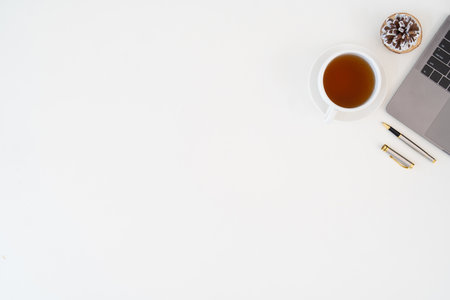 Top view above of white office desk table with keyboard computer, notebook and coffee cup with equipment other office supplies. business concept. workplace, flat lay with blank copy spaceの写真素材
