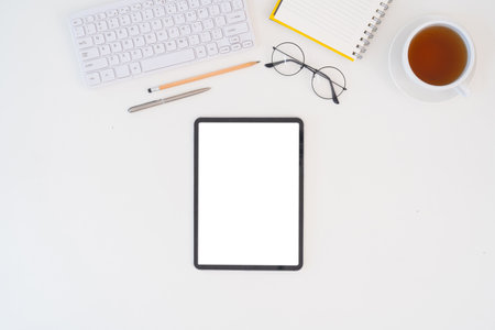 Modern desk workspace with blank copy space mockup with blank screen tablet, coffee cup, technology,...