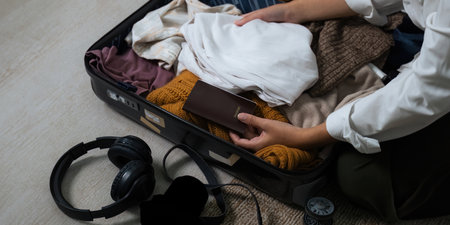Close up young asian woman traveler pack bags prepare for the travel season vacation, concept travel lifestyle active journey and trip travel, passportの写真素材
