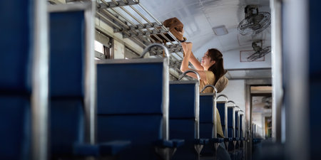 asian woman young stand interior of the train looking at Placing luggage for tourism backpacker. concept transport lifestyle active journey and travel adventureの写真素材