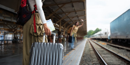 female tourist go on a traveling trip look at the map and walking with luggage at train station. concept transport lifestyle active journey and travel adventureの写真素材