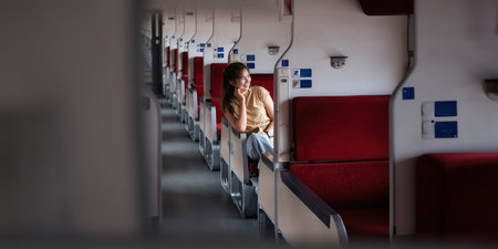 Traveler young woman travel in train on during sitting inside. travelling tourist have small trip...
