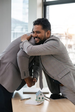 Real estate agent African American handshake to customer indian to congratulate after signing a...