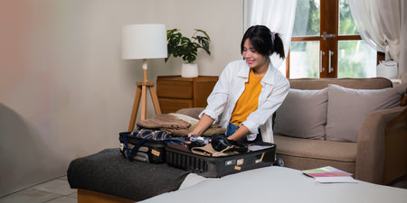 Young asian woman traveler pack bags prepare for the travel season vacation, concept lifestyle active journey and trip travel, passportの写真素材