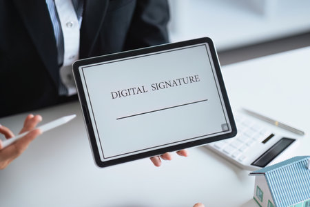 Close-up of female hand signing e-document with on tablet. Electronic signature and modern technologies conceptの写真素材