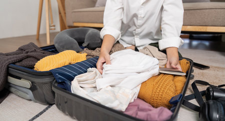 Portrait of beauty asian traveler woman pack prepare stuff and outfit clothes in suitcase travel bag...