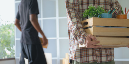 Handsome asian man hold of large cardboard box for moving homeの写真素材