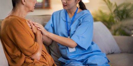 Empathy, trust and nurse caregiver holding hands with patient. consulting support and healthcare advice. Kindness, counseling and medical therapy in nursing home for hope, consultation and psychologyの写真素材