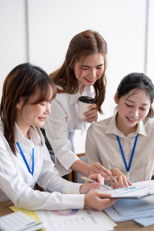 Team employee collaboration discussing working analyzing with financial data and marketing growth report graph in team, brainstorming to strategy planning making profit of companyの写真素材