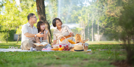 Grandparent playing togetherness with a granddaughter in the park in the morning. Family, love and grandchild bonding with grandfather and grandma in a park. concept child and seniorの写真素材