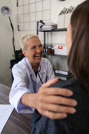 Female doctor giving hope and encouragement to stress woman patient at hospital. Doctor woman touching on patient shoulder to support take care and help. Support and encouragedの写真素材