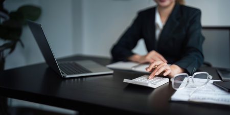 Close up of businessperson analysis and calculate chart and graph showing change and growth on the...