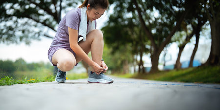 Young woman stretch during stretching exercise outdoors in the parkの写真素材