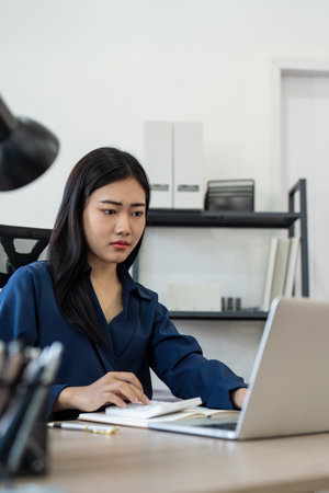 Professional businesswoman working at her home via laptop, young female manager using computer...